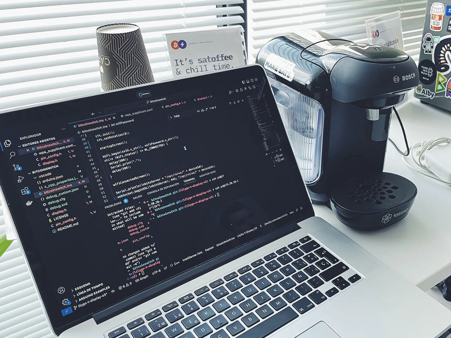 Laptop with the Satoffee code next to the coffee machine
