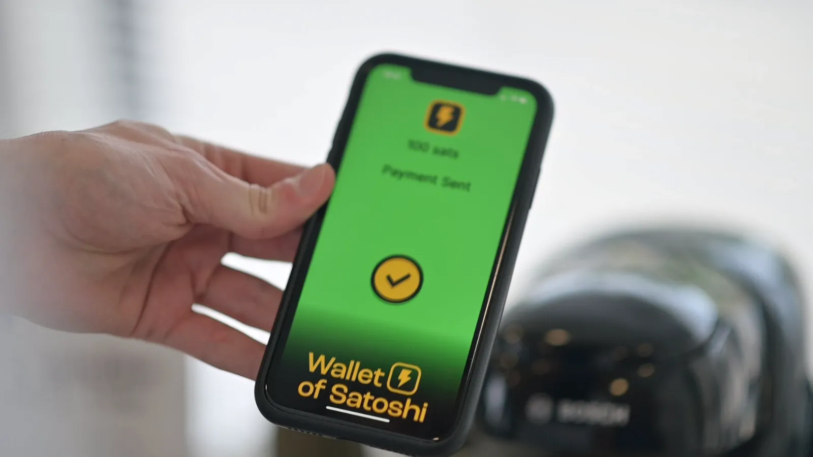 Paying for a coffee with a Lightning wallet on a phone